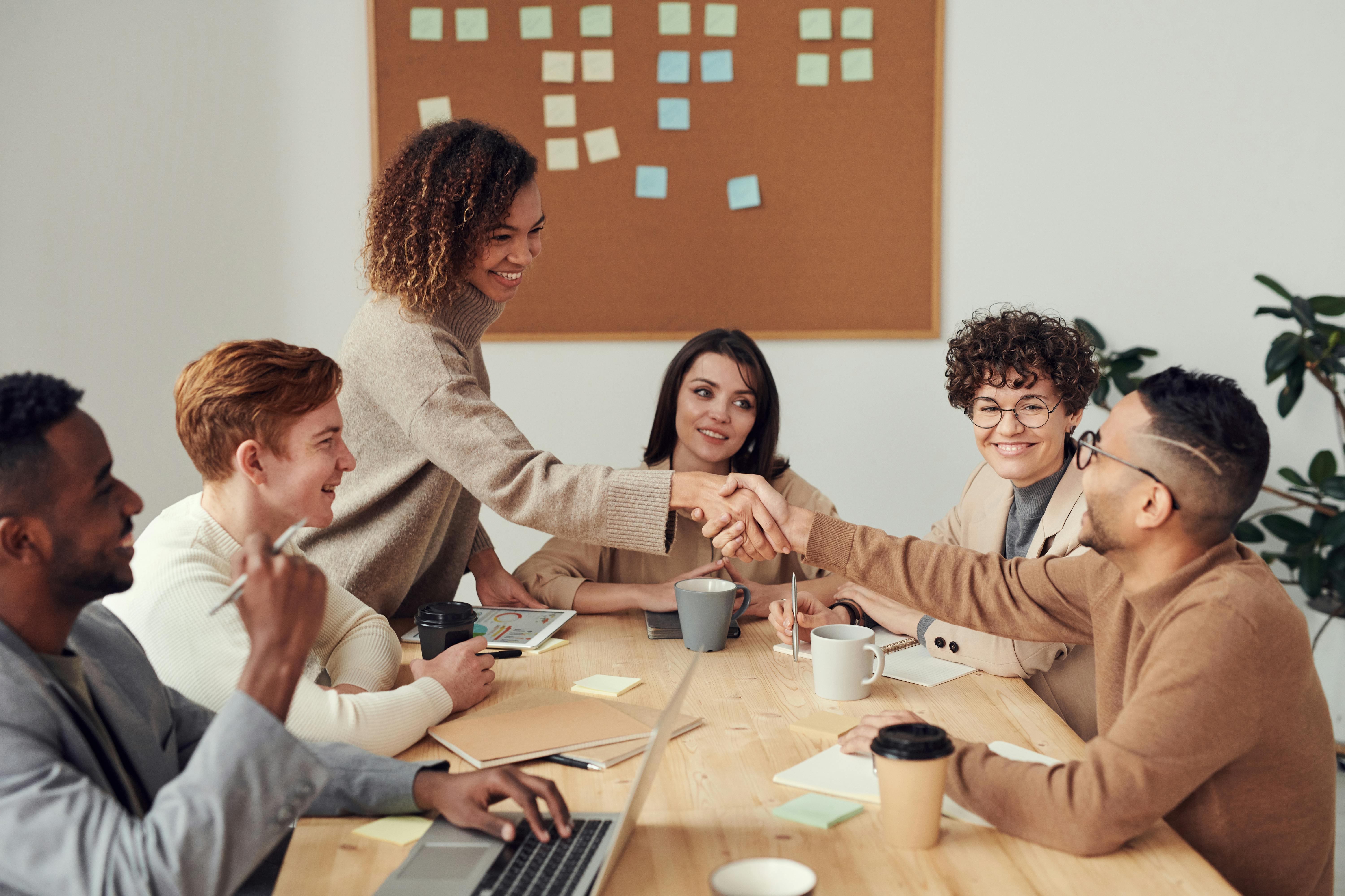 A diverse group of founders collaborating around a table during a working session.