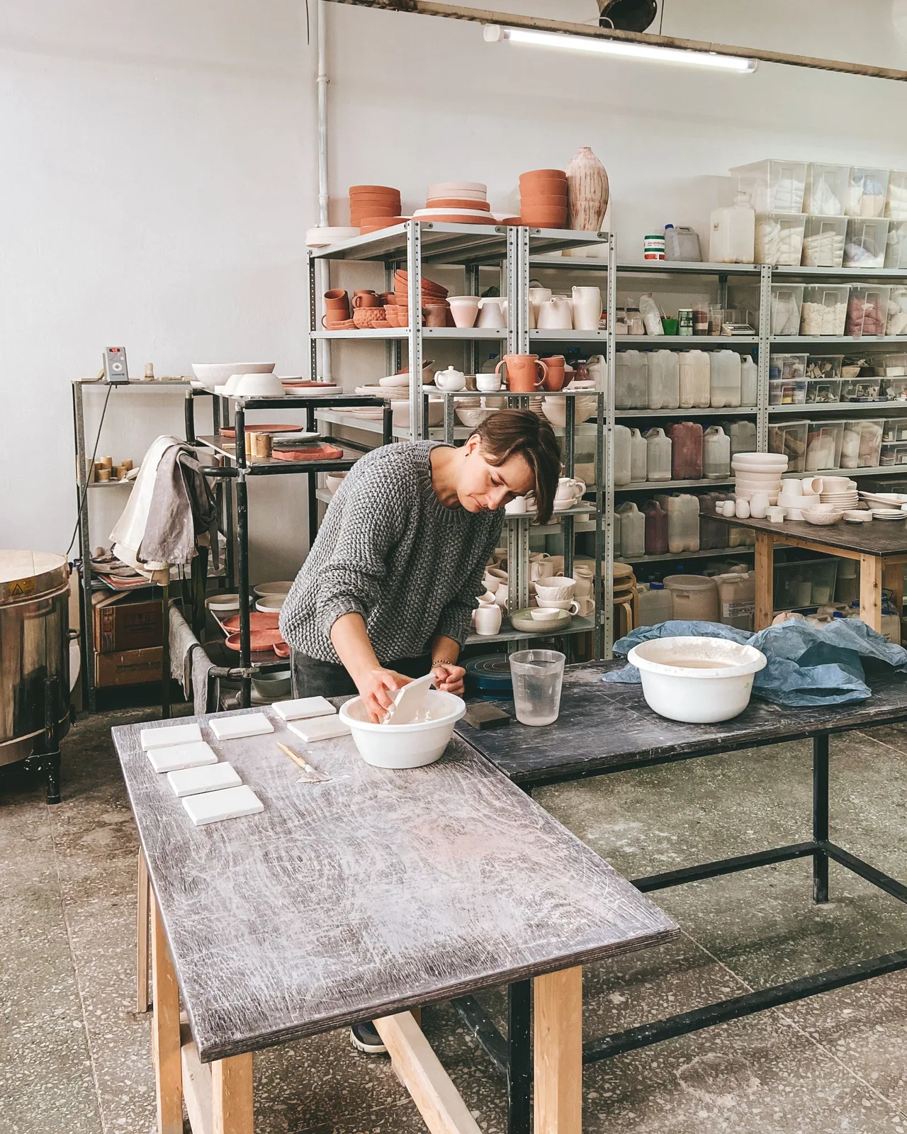 A ceramicist making pottery in her workshop.