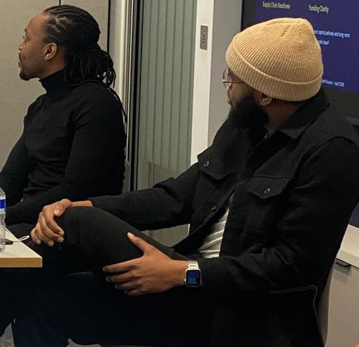 Founders sharing ideas around a table at a FairBuild community session.