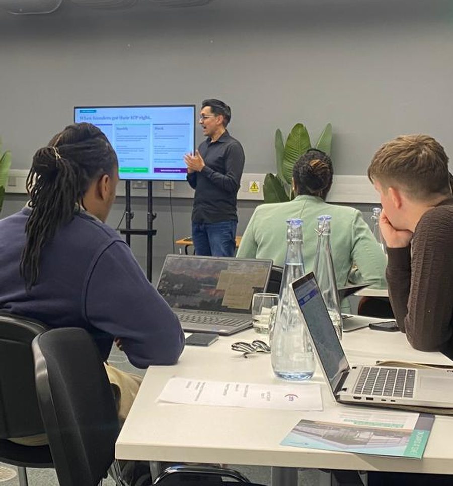 A facilitator presenting to founders during a FairBuild workshop.