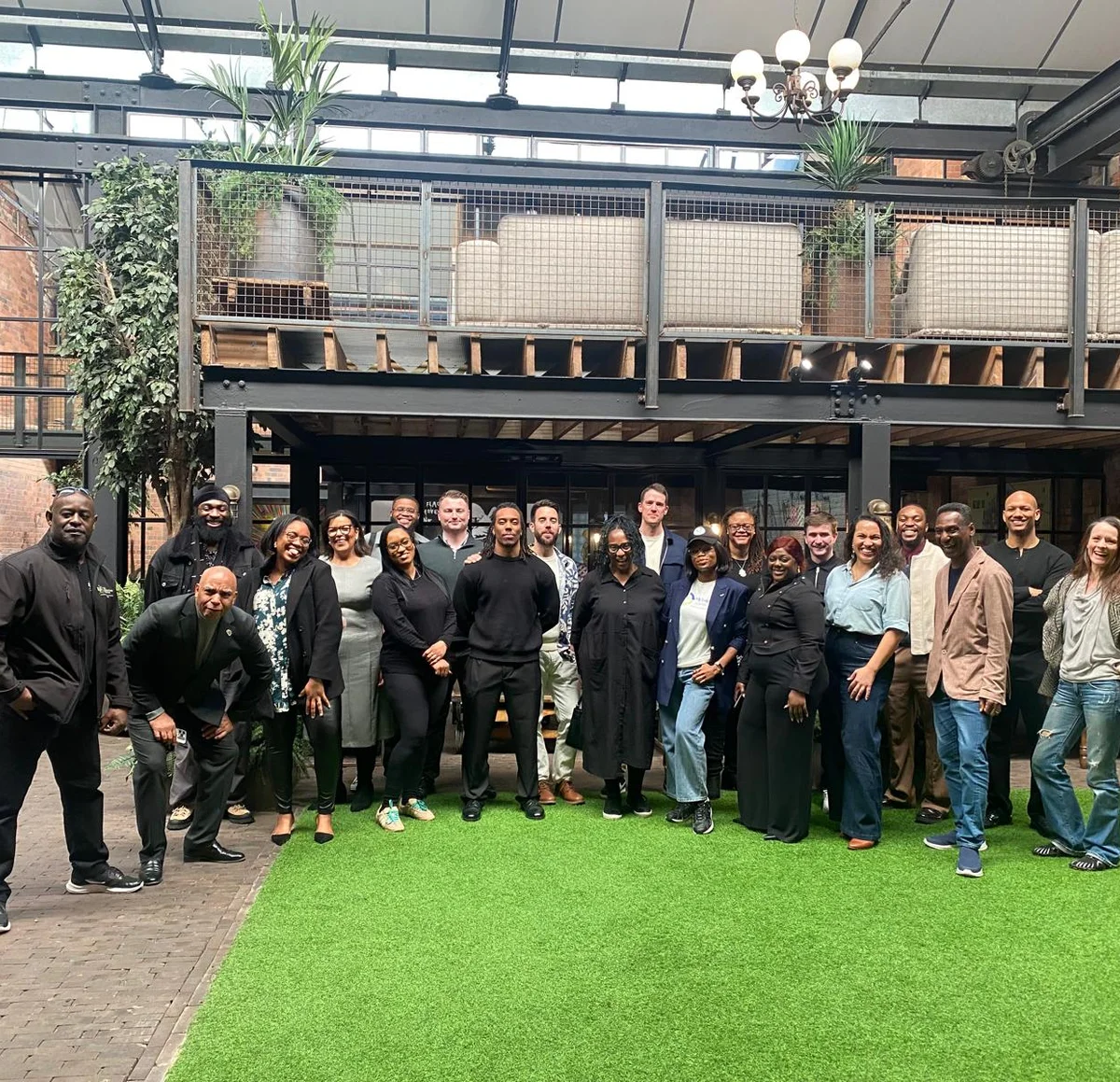 Founders and community members gathered together in a courtyard.